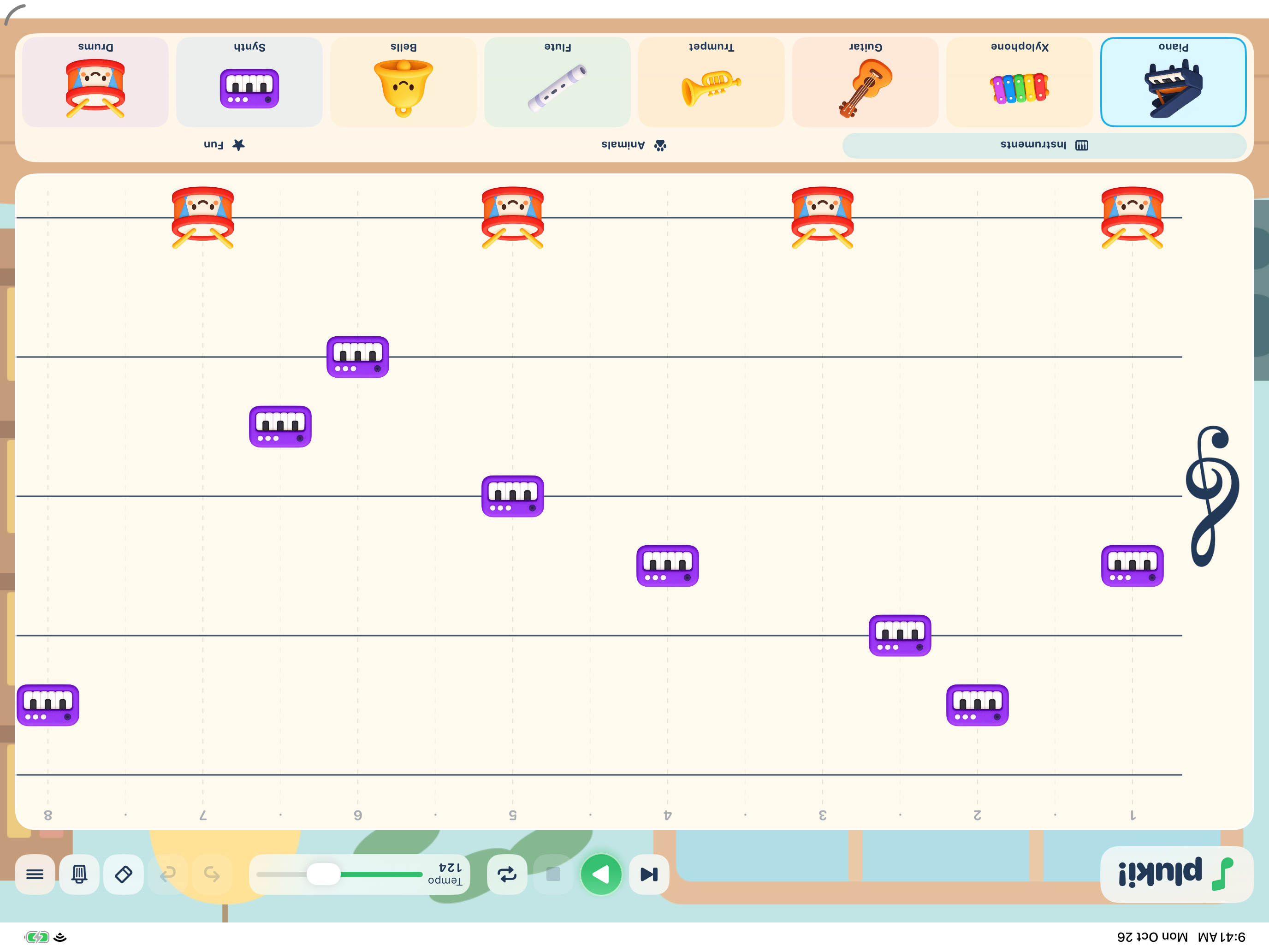 Pluki on iPad, with colorful instrument stickers arranged on a music sheet